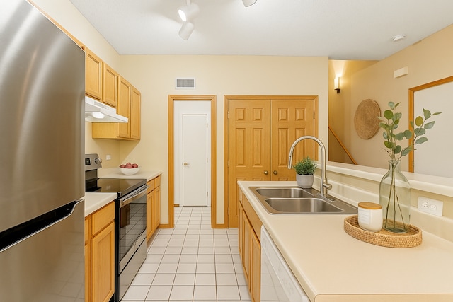 3730 Vermilion Ct S Unit 509, Eagan, MN 55122 - kitchen featuring appliances with stainless steel finishes, under cabinet range hood, light brown cabinetry, light tile patterned flooring, and light countertops