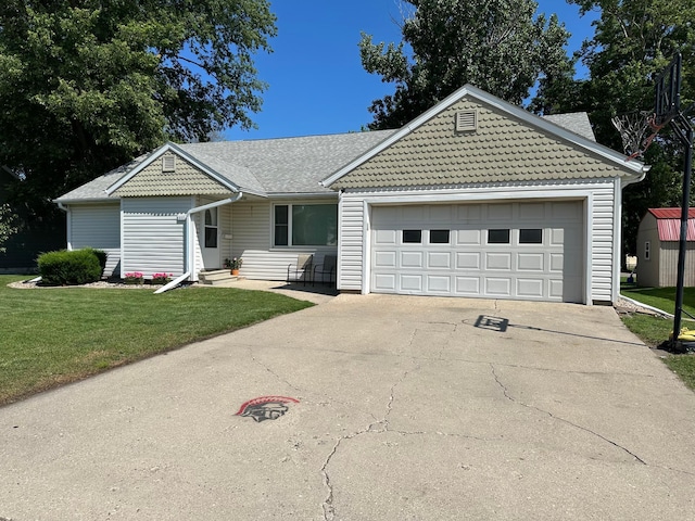 317 Clary St, Worthington, MN 56187 - view of front of property featuring a front yard, concrete driveway, an attached garage, and a shed