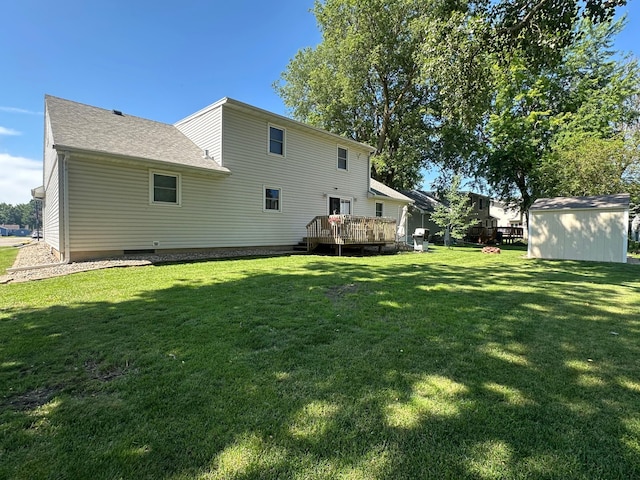 317 Clary St, Worthington, MN 56187 - rear view of house featuring a yard, a wooden deck, and roof with shingles