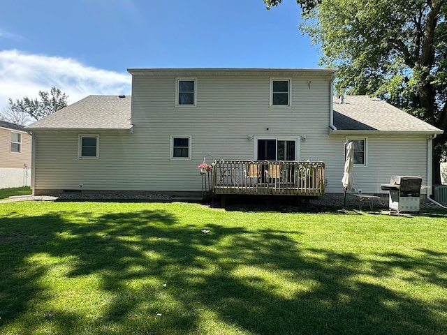 317 Clary St, Worthington, MN 56187 - back of property with a deck, a yard, and roof with shingles