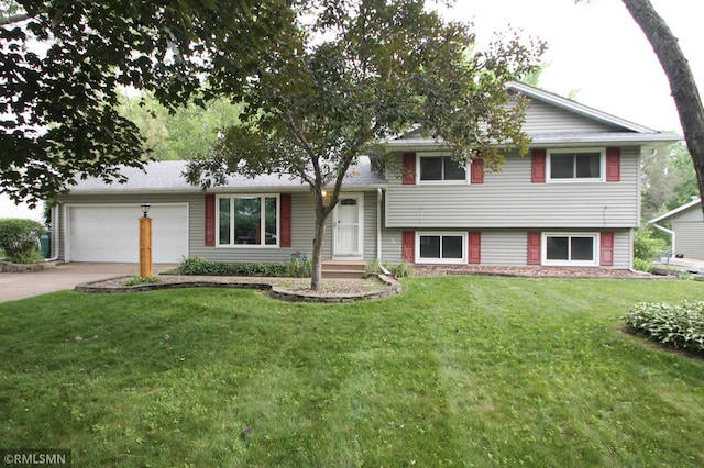 10628 Direct River Dr NW, Coon Rapids, MN 55433 - tri-level home with concrete driveway, a garage, and a front lawn