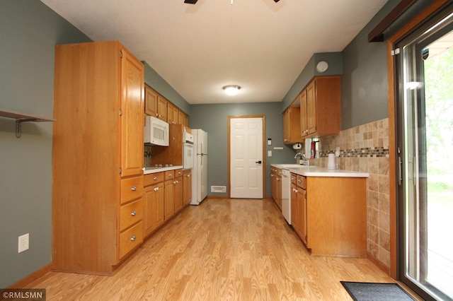 10628 Direct River Dr NW, Coon Rapids, MN 55433 - kitchen with white appliances, light wood-style floors, light countertops, and a ceiling fan