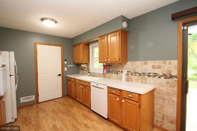 10628 Direct River Dr NW, Coon Rapids, MN 55433 - kitchen featuring white appliances, light wood finished floors, light countertops, and healthy amount of natural light