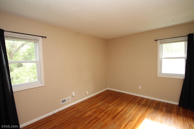 10628 Direct River Dr NW, Coon Rapids, MN 55433 - spare room featuring wood finished floors and baseboards