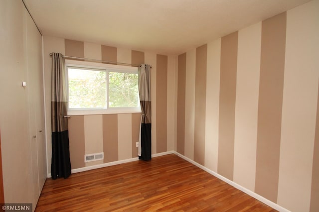 10628 Direct River Dr NW, Coon Rapids, MN 55433 - empty room with wood finished floors