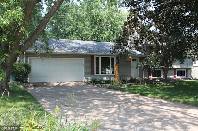 10628 Direct River Dr NW, Coon Rapids, MN 55433 - view of front of house featuring concrete driveway, a garage, and a front lawn