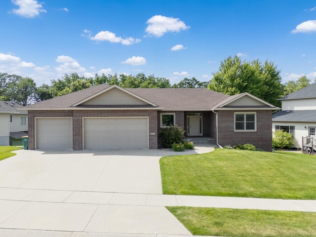 2309 Teakwood Ln SW, Rochester, MN 55902 - ranch-style house with an attached garage, a front yard, concrete driveway, brick siding, and a shingled roof