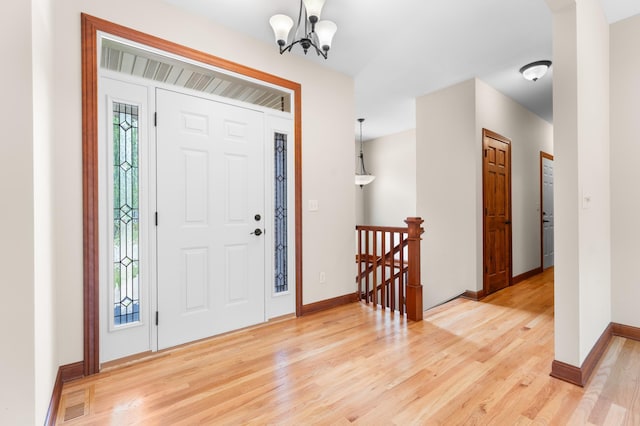 2309 Teakwood Ln SW, Rochester, MN 55902 - entryway with light wood finished floors and a chandelier