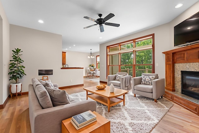 2309 Teakwood Ln SW, Rochester, MN 55902 - living room featuring a fireplace, light wood-style floors, ceiling fan, recessed lighting, and a chandelier