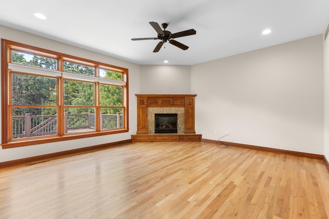 2309 Teakwood Ln SW, Rochester, MN 55902 - unfurnished living room featuring light wood finished floors, recessed lighting, a tile fireplace, and a ceiling fan