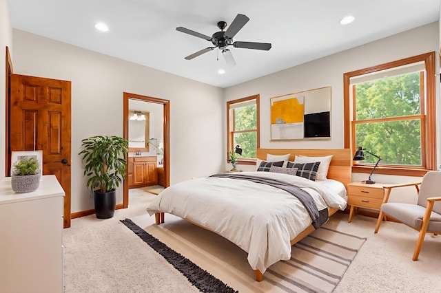 2309 Teakwood Ln SW, Rochester, MN 55902 - bedroom with light carpet, multiple windows, recessed lighting, ensuite bathroom, and a ceiling fan