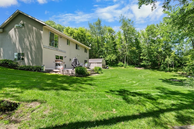 15784 103rd St SE, Becker Twp, MN 55308 - rear view of property featuring a deck, a lawn, and a storage shed