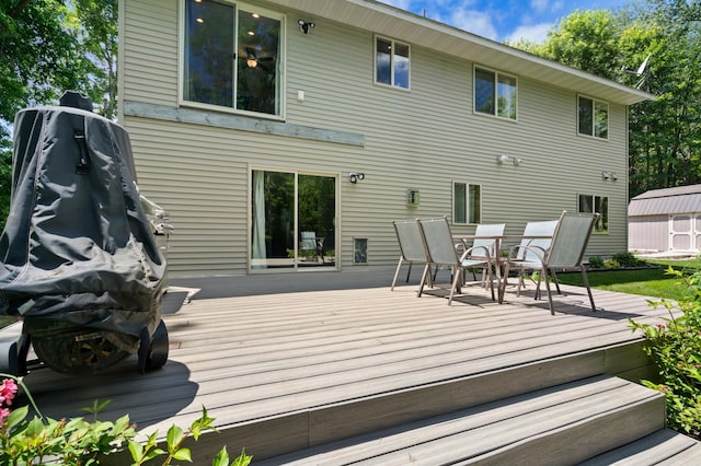 15784 103rd St SE, Becker Twp, MN 55308 - deck with outdoor dining area and a storage unit