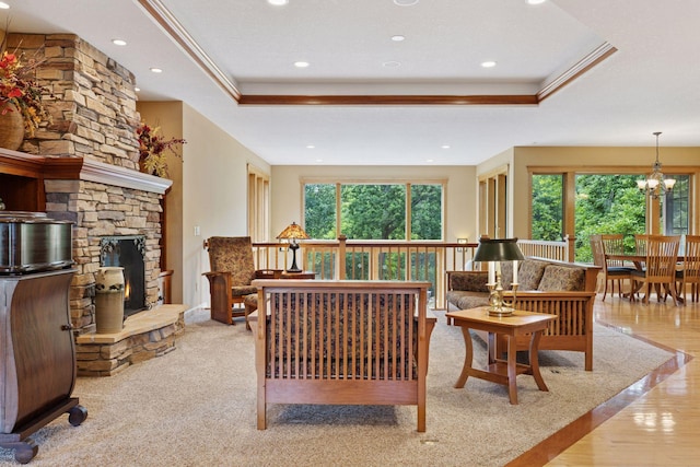 9449 Ehler Ave SE, Delano, MN 55328 - living area featuring a raised ceiling, recessed lighting, a chandelier, a stone fireplace, and crown molding