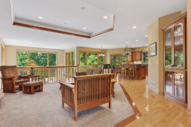 9449 Ehler Ave SE, Delano, MN 55328 - living area with a raised ceiling, recessed lighting, light wood finished floors, and a chandelier