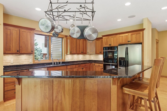 9449 Ehler Ave SE, Delano, MN 55328 - kitchen featuring stainless steel fridge with ice dispenser, backsplash, a kitchen bar, brown cabinets, and recessed lighting