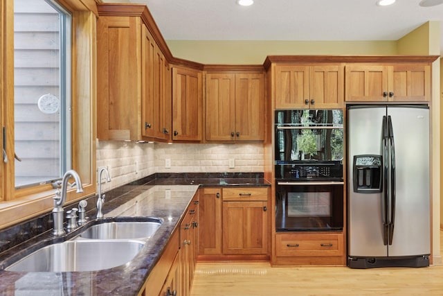 9449 Ehler Ave SE, Delano, MN 55328 - kitchen featuring stainless steel refrigerator with ice dispenser, dark stone countertops, brown cabinetry, recessed lighting, and tasteful backsplash