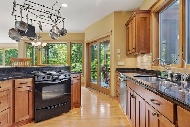 9449 Ehler Ave SE, Delano, MN 55328 - kitchen featuring black range with gas stovetop, dishwasher, light wood-style floors, a chandelier, and dark stone countertops