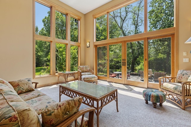 9449 Ehler Ave SE, Delano, MN 55328 - sunroom / solarium featuring french doors, carpet floors, a towering ceiling, and plenty of natural light