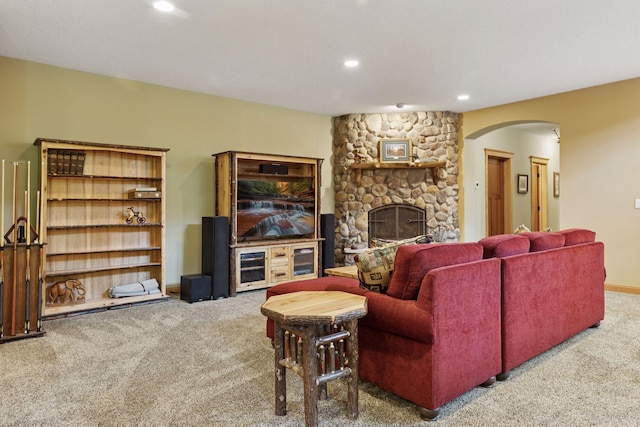 9449 Ehler Ave SE, Delano, MN 55328 - living area with carpet, arched walkways, recessed lighting, and a stone fireplace