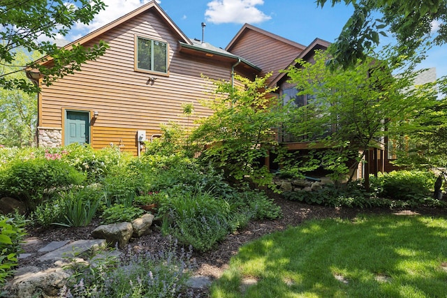 9449 Ehler Ave SE, Delano, MN 55328 - view of home's exterior with stone siding and a lawn