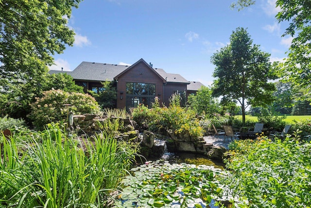 9449 Ehler Ave SE, Delano, MN 55328 - rear view of house with a garden pond and a patio area