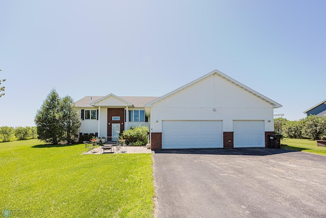 17123 Lakeview Ln, Audubon, MN 56511 - view of front facade with brick siding, asphalt driveway, an attached garage, and a front lawn