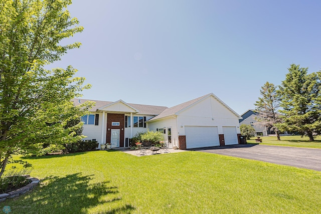 17123 Lakeview Ln, Audubon, MN 56511 - view of front of home with brick siding, a front yard, asphalt driveway, and a garage