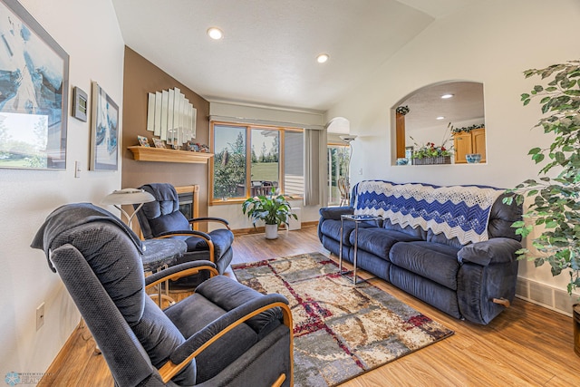 17123 Lakeview Ln, Audubon, MN 56511 - living room featuring wood finished floors, recessed lighting, arched walkways, and lofted ceiling