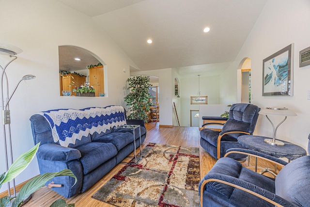 17123 Lakeview Ln, Audubon, MN 56511 - living room with lofted ceiling, arched walkways, wood finished floors, and recessed lighting