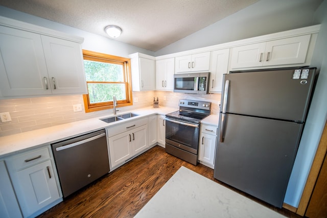 724 50th Ave NW, Rochester, MN 55901 - kitchen with stainless steel appliances, dark wood-style floors, lofted ceiling, white cabinets, and backsplash