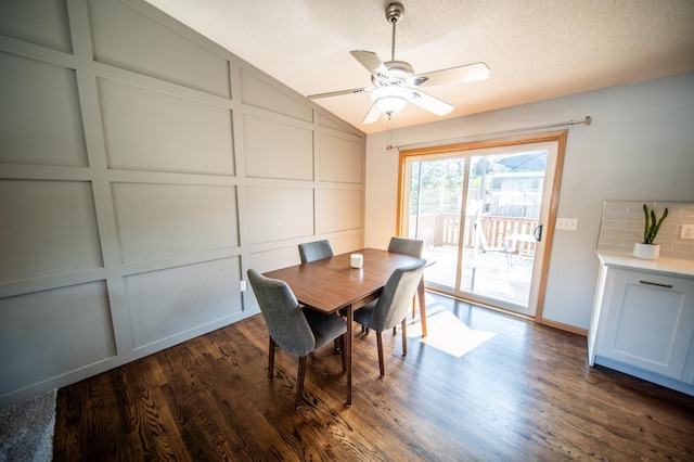 724 50th Ave NW, Rochester, MN 55901 - dining space featuring lofted ceiling, dark wood-style flooring, ceiling fan, a textured ceiling, and a decorative wall