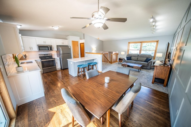 724 50th Ave NW, Rochester, MN 55901 - dining room featuring dark wood-style floors, vaulted ceiling, and a ceiling fan