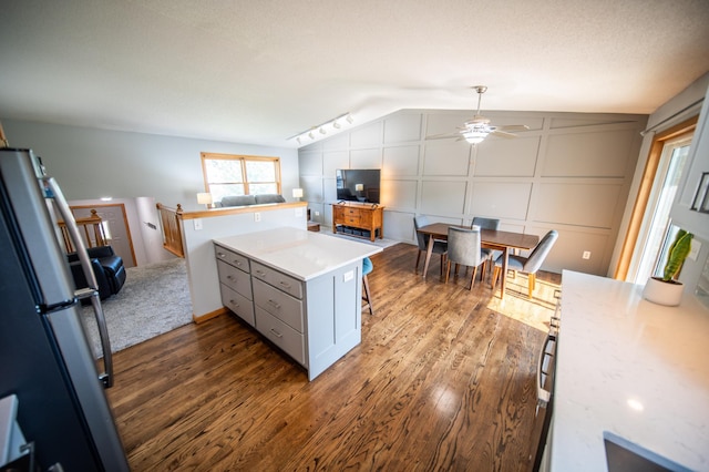 724 50th Ave NW, Rochester, MN 55901 - kitchen with freestanding refrigerator, ceiling fan, light countertops, dark wood-style floors, and lofted ceiling