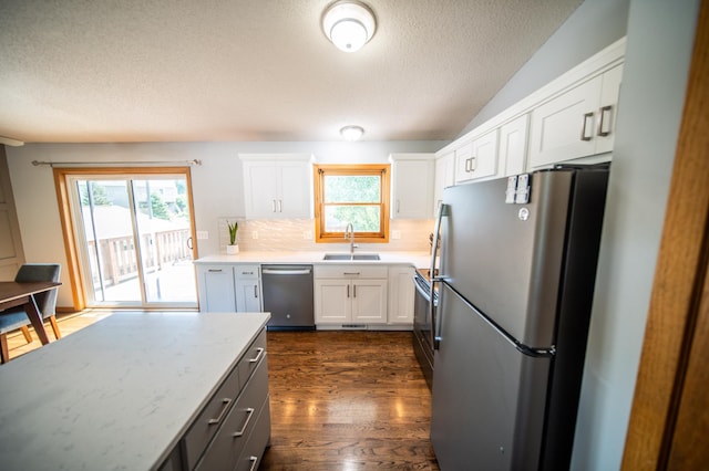 724 50th Ave NW, Rochester, MN 55901 - kitchen featuring stainless steel appliances, a textured ceiling, tasteful backsplash, white cabinetry, and healthy amount of natural light