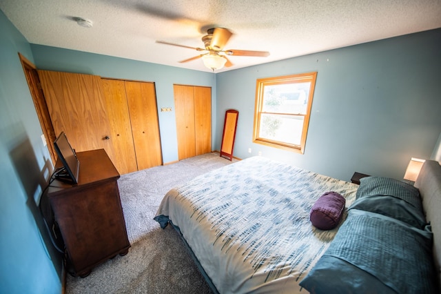 724 50th Ave NW, Rochester, MN 55901 - bedroom with carpet, two closets, a ceiling fan, and a textured ceiling