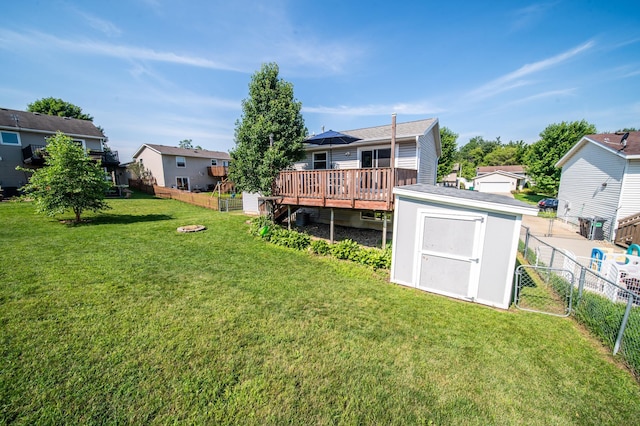 724 50th Ave NW, Rochester, MN 55901 - rear view of property with a storage unit, a wooden deck, a fenced backyard, and a residential view