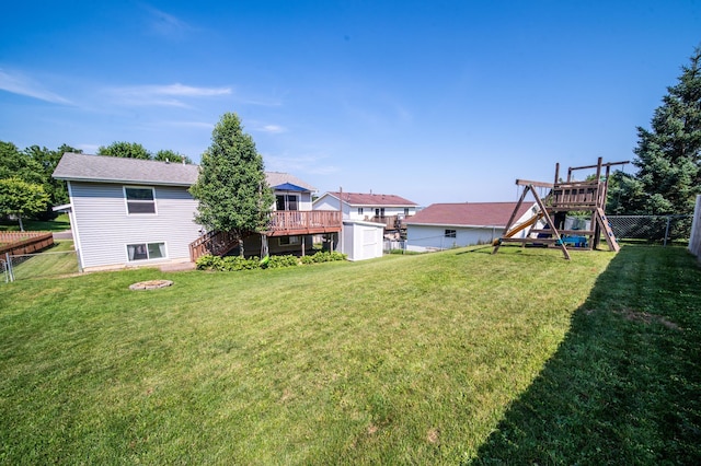 724 50th Ave NW, Rochester, MN 55901 - fenced backyard featuring a playground, a deck, and stairway