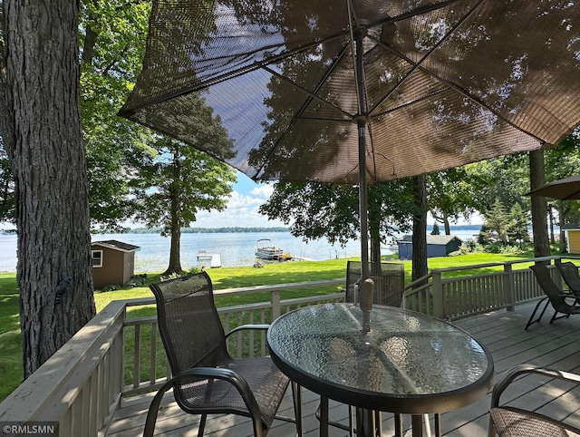11436 Hoyer Ave NW, Annandale, MN 55302 - deck featuring a water view, a yard, and outdoor dining area