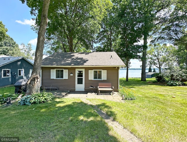 11436 Hoyer Ave NW, Annandale, MN 55302 - back of house featuring a patio, a yard, a water view, and roof with shingles