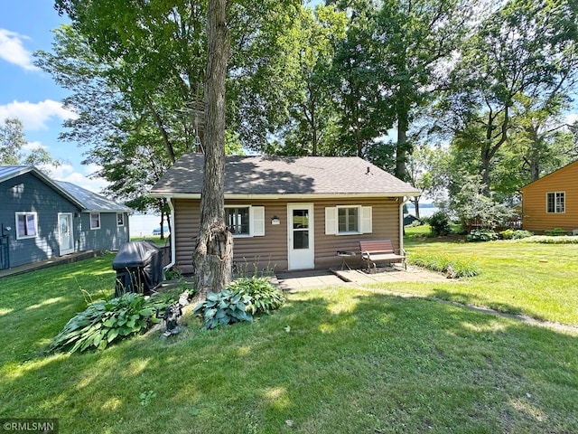11436 Hoyer Ave NW, Annandale, MN 55302 - back of house featuring a yard and a shingled roof