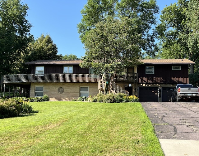 806 Highland Rd, Windom, MN 56101 - view of property with a front yard, driveway, stairs, a garage, and board and batten siding