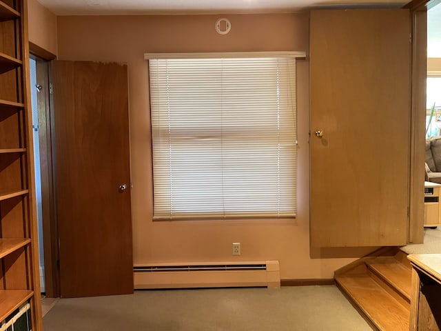 806 Highland Rd, Windom, MN 56101 - doorway to outside featuring a baseboard heating unit and carpet flooring