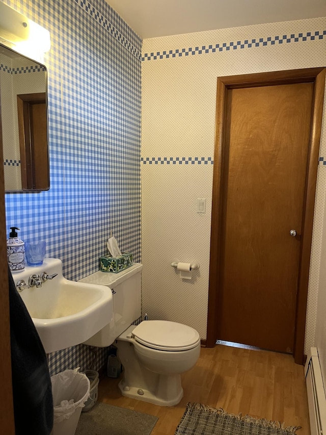 806 Highland Rd, Windom, MN 56101 - bathroom with wood finished floors and a baseboard heating unit