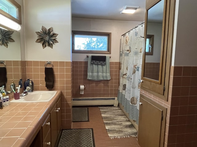 806 Highland Rd, Windom, MN 56101 - full bath featuring baseboard heating, tile walls, wainscoting, vanity, and tile patterned flooring