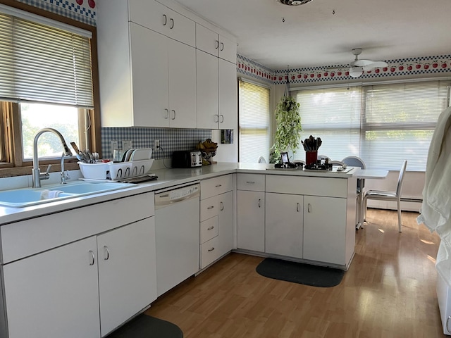 806 Highland Rd, Windom, MN 56101 - kitchen with white dishwasher, a ceiling fan, light wood-style floors, a baseboard radiator, and light countertops