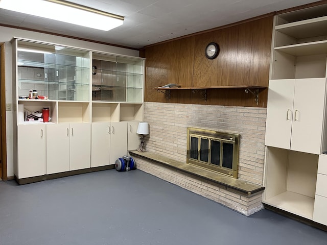 806 Highland Rd, Windom, MN 56101 - unfurnished living room featuring concrete floors, a brick fireplace, and wooden walls