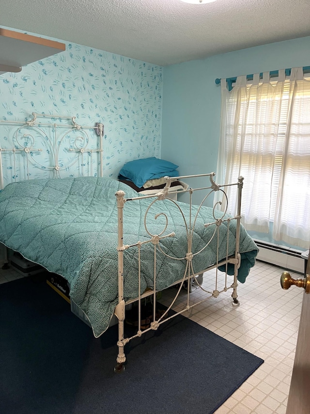 806 Highland Rd, Windom, MN 56101 - bedroom with a baseboard heating unit, wallpapered walls, and a textured ceiling