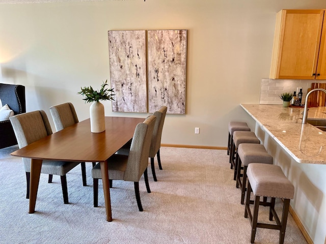 2100 Old School Rd Unit 206, Mound, MN 55364 - dining space featuring light carpet and baseboards