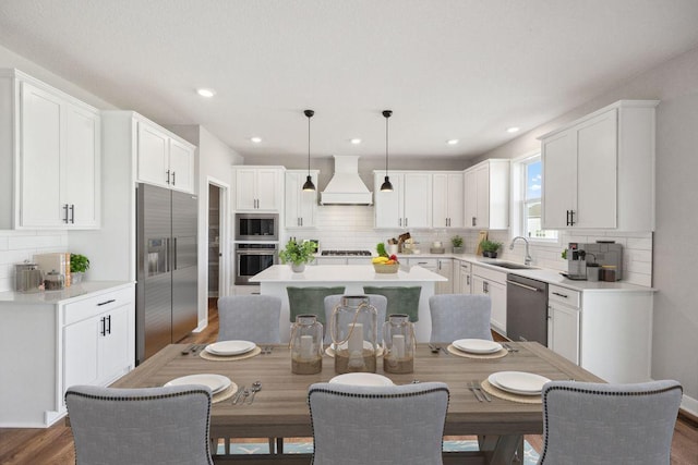 898 Laurel Ct, Chaska, MN 55318 - kitchen featuring stainless steel appliances, custom range hood, a center island, decorative backsplash, and dark wood finished floors